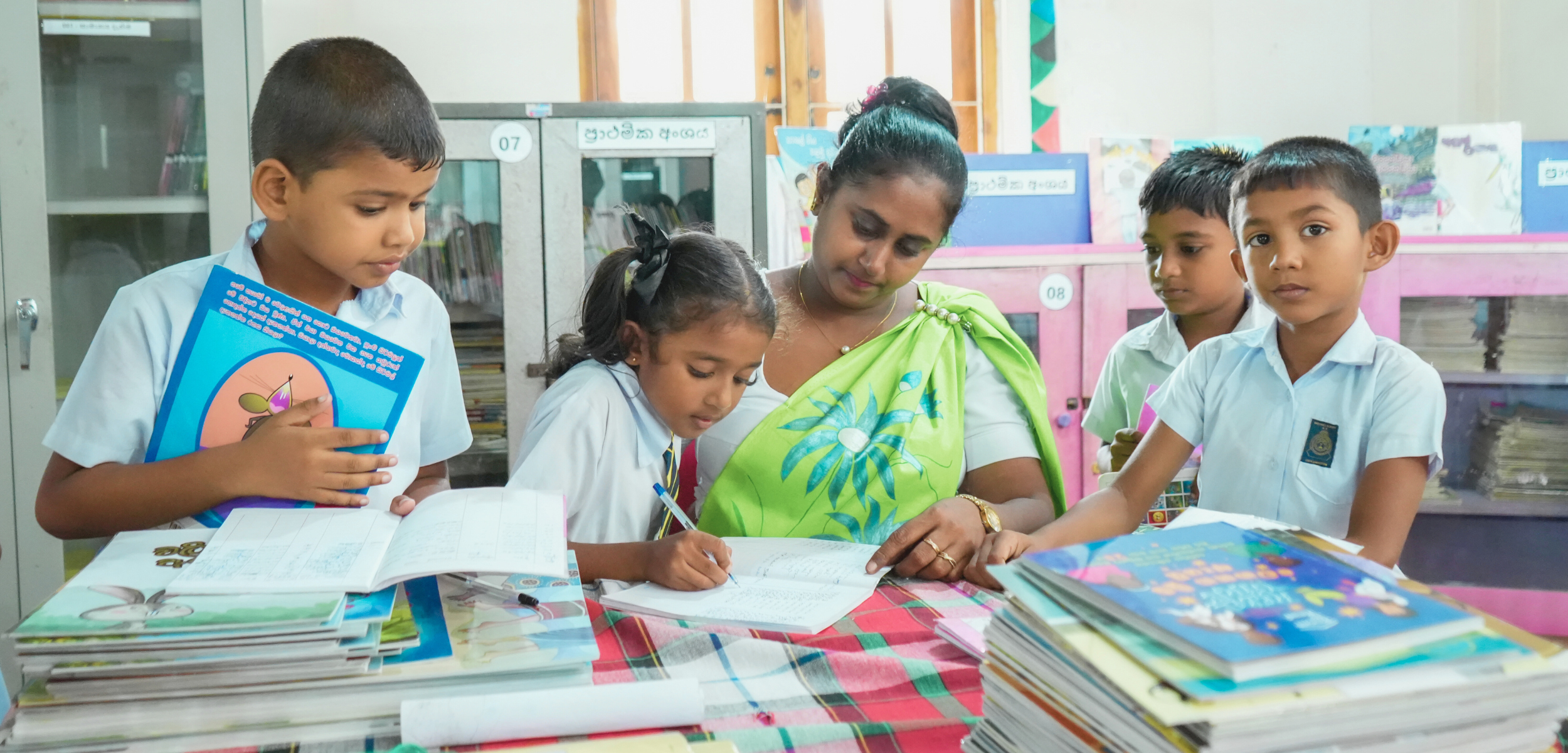 International Literacy Day, children checking out books from a Room to Read library in Sri Lanka